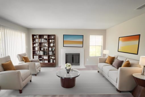 a living room with white furniture and a fireplace