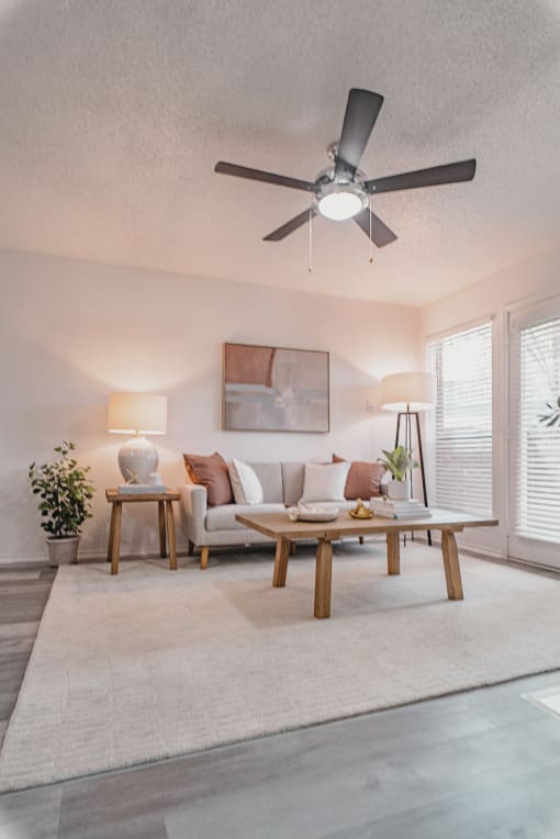 a living room with a ceiling fan and a couch