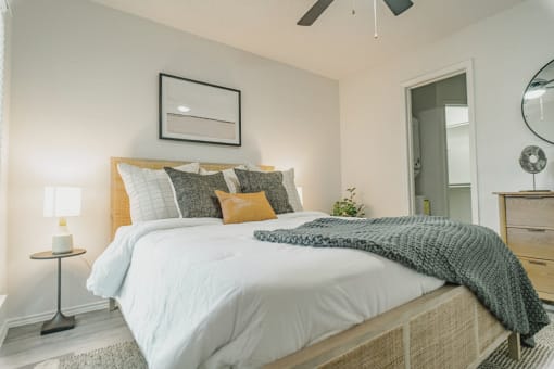 a bedroom with a large bed and a ceiling fan
