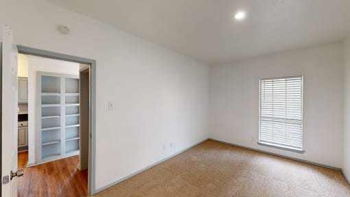 a living room with white walls and a door to a closet