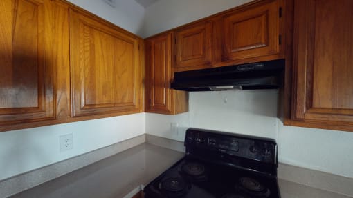 a kitchen with wooden cabinets and a stove and a black oven