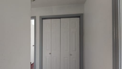 an open door with two white closet doors