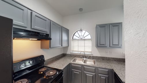 a kitchen with a sink and a stove and a window