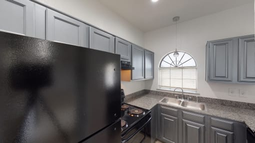 a kitchen with stainless steel appliances and granite counter tops