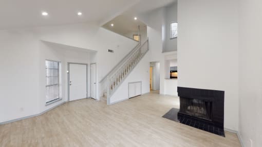 a large white room with a black fireplace and geometric shapes on the walls