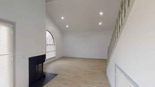 a living room with a fireplace and white walls