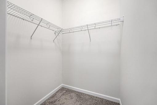 A white wall with a metal rack on it.