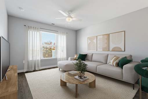 A living room with a grey sofa, a wooden table, a television, and a window with curtains.