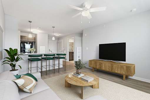 A living room with a white couch, a wooden coffee table, and a black television.