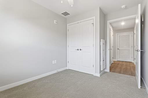 A white door is open to a hallway.