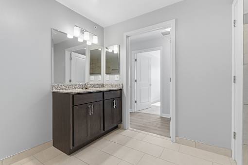 A bathroom with a vanity and mirrors.