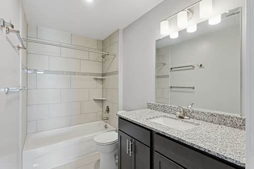A white bathroom with a sink, toilet, and bathtub.