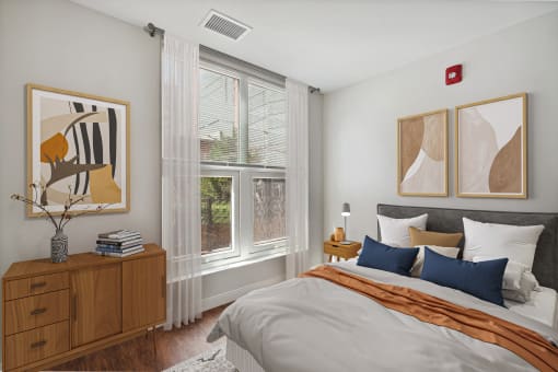 a bedroom with a bed and two windows