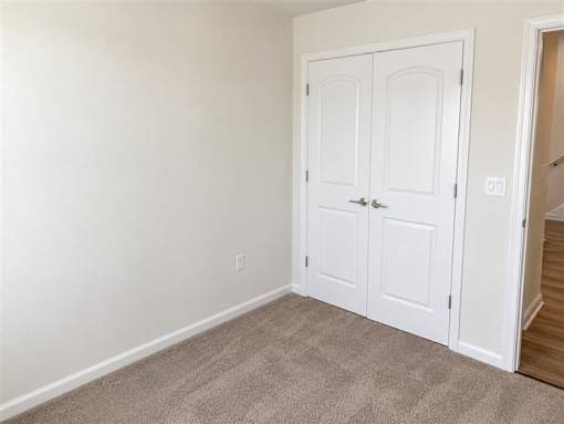 A white double door is closed with a silver handle.