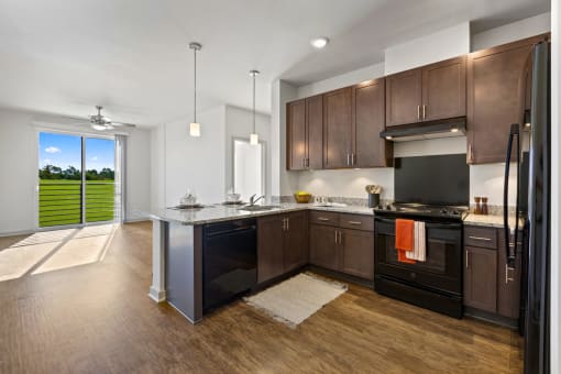 a kitchen with dark wood cabinets and a large island with granite countertops