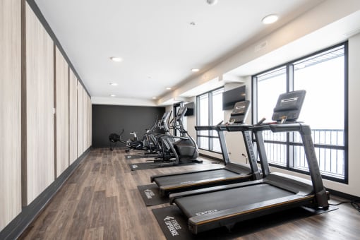 a gym with treadmills and elliptical machines