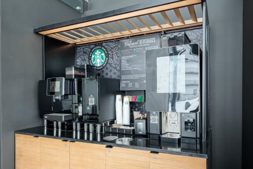 a coffee counter with a coffee menu and coffee machines
