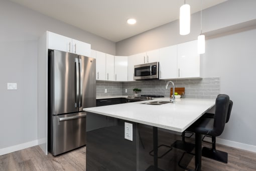 a kitchen with stainless steel appliances and a white counter top