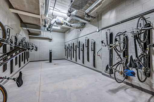 A bike parking area with bikes on the wall.