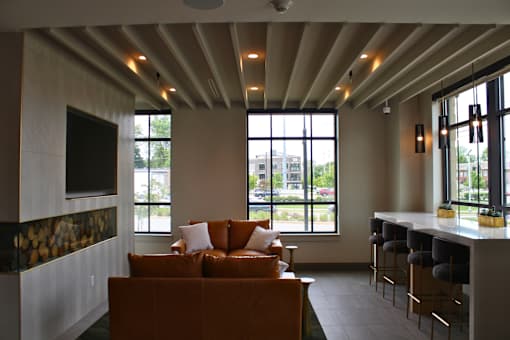 A living room with a couch and a bar area.