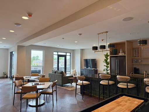 A modern kitchen and dining area with a wooden table and chairs.