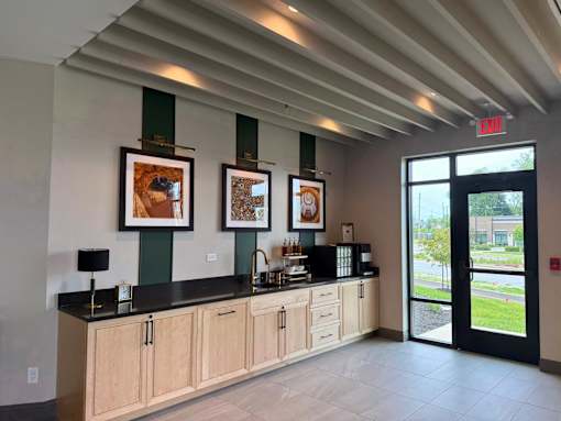 A reception area with a black counter and two framed pictures on the wall.