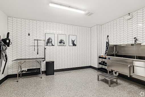 A room with a wallpapered wall and a sink.