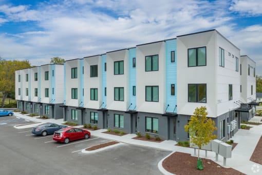a view of a building with cars parked in front of it