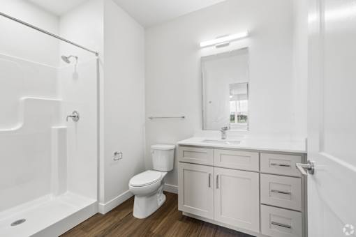 A white bathroom with a toilet, sink, and bathtub.
