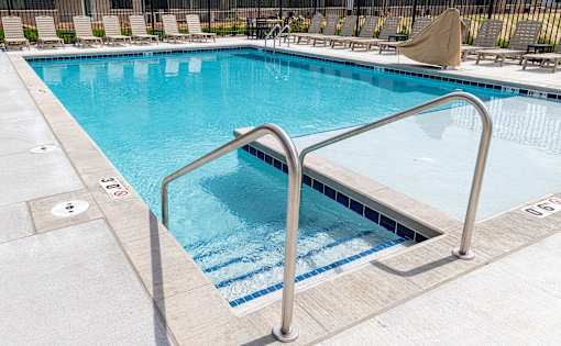 A swimming pool with a metal ladder.