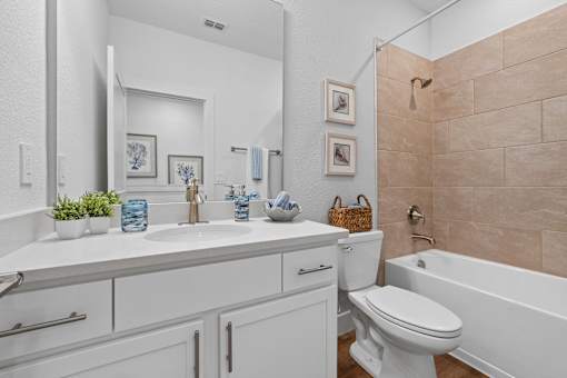 A bathroom with a white sink and toilet.
