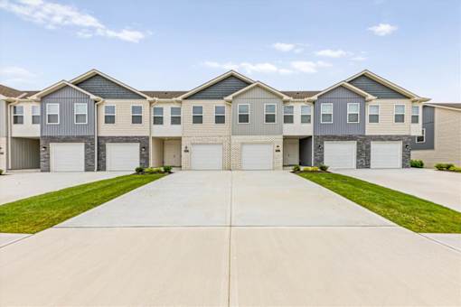 A row of houses with garages in front.