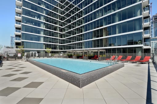 a swimming pool in front of a tall building