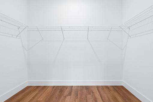 Empty room with white walls and wooden floor.