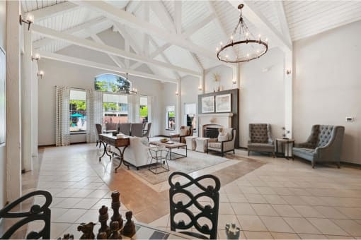 a large living room with chairs and a table