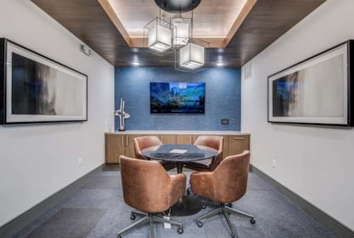 A conference room with a table and chairs.