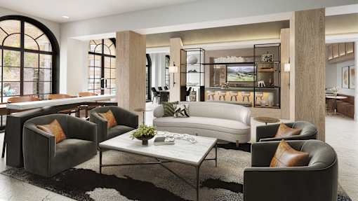 A modern living room with a large window and a view of trees.