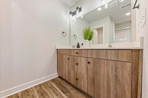 A bathroom vanity with a mirror and lights above it.
