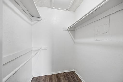 A white wall with a switch and a light fixture.