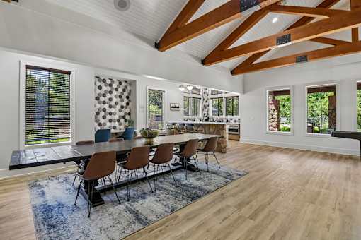A dining room with a long table and chairs.