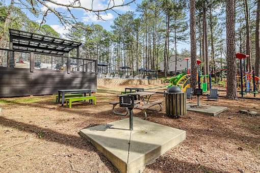 A playground with a swing set and a seesaw.