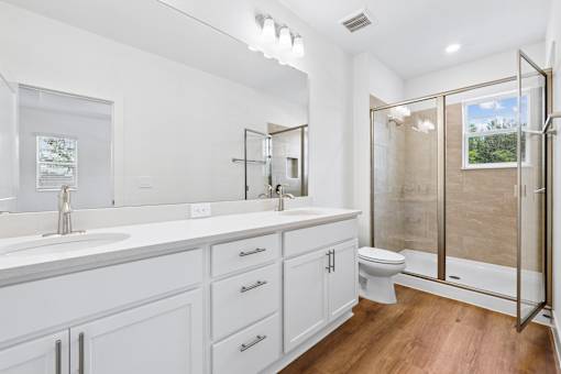 A white bathroom with a walk-in shower.
