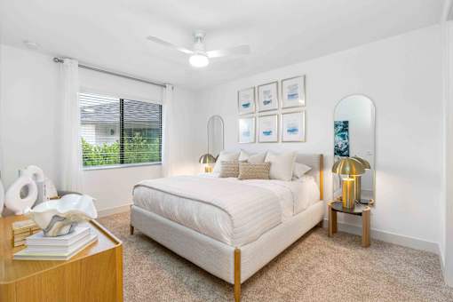 a white bedroom with a bed and a window