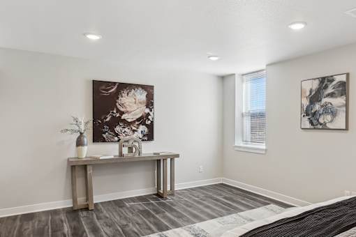 A room with a wooden table and two paintings on the wall.