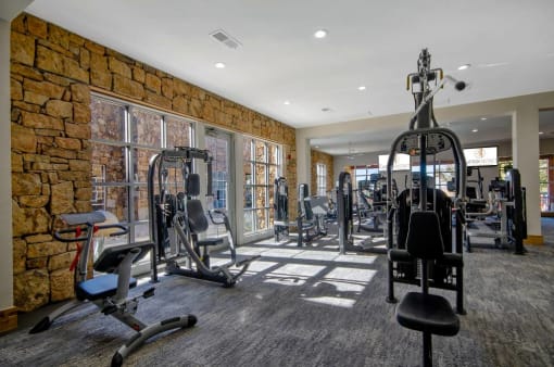 Fitness center with cardio equipment, strength training equipment, and free weights
