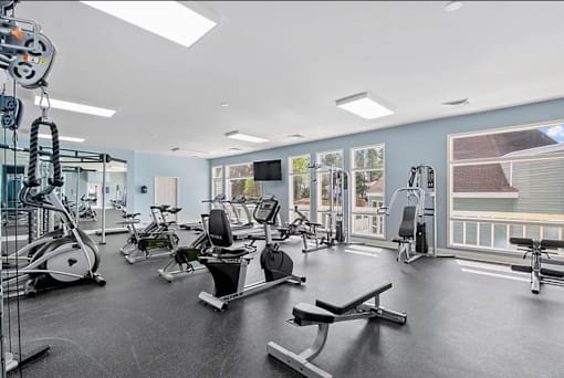 A gym with a variety of exercise equipment.