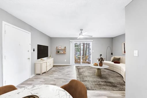 A living room with a white ceiling and a television.