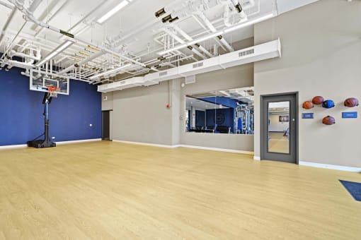 the multipurpose room has a dance floor and a blue wall and white ceiling