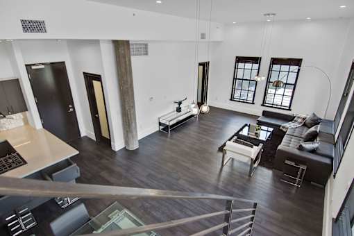 A modern open concept living room with a kitchen area.