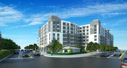 A modern apartment building with cars parked in front.